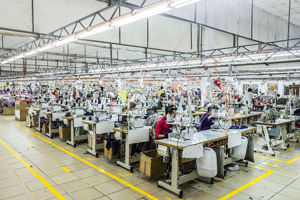 Gracias a su esfuerzo, Srey Sros ascendió al puesto de supervisora y es la jefa de una sección que se ocupa de cortar dobladillos para la ropa que se confecciona en la fábrica. Foto: ONU Mujeres/Charles Fox.